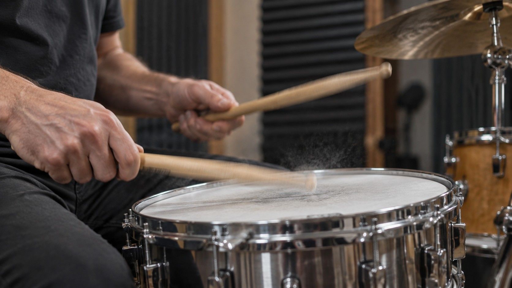 Drum kit beside an audio waveform display